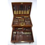 An oak canteen containing a set of EPNS rat-tail flatware for six,