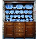 A George III oak breakfront high dresser,