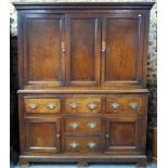 An 18th century jointed oak housekeepers cabinet having a pair of fielded panel doors flanking a