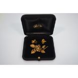 A brooch and earring suite of leaf and rose motif, 18ct yellow gold, approx 16g,