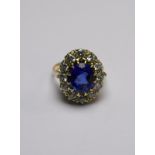 A large oval sapphire and diamond cluster ring,