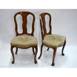 A pair of marquetry inlaid walnut side chairs decorated with urn,