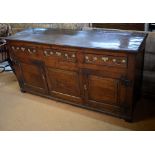 An 18th century oak low dresser,