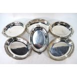 A set of three EPNS oval entree dishes and covers with twin handles and beaded rims