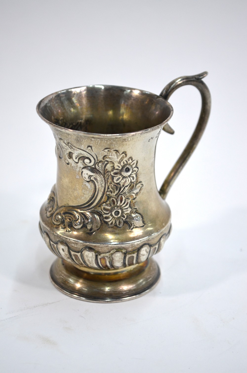 A late Victorian silver baluster Christening mug with embossed decoration, Edward Samuel Jones,