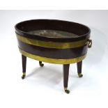 A 19th century brass bound mahogany wine cooler of ovoid form, with brass handles,