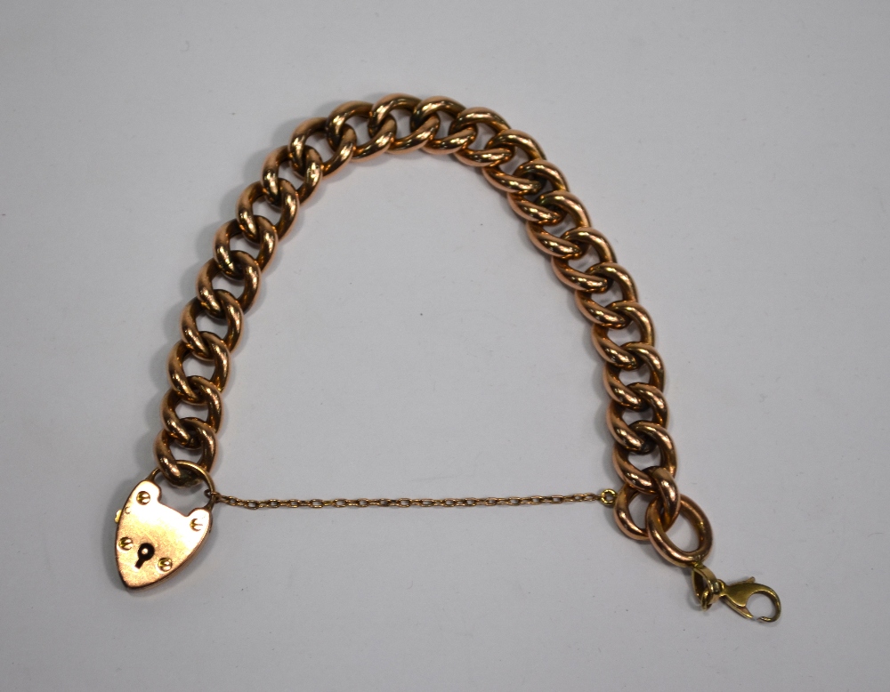 A rose-coloured metal curb bracelet having padlock attached, padlock stamped 9ct, - Image 2 of 3