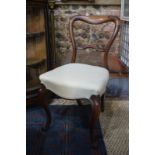 A set of eight Victorian rosewood side chairs with overstuffed serpentine seats,