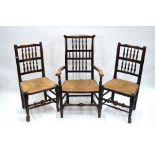 A matched set of six early 19th century stained ash spindle-back dining chairs with rush seats,