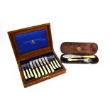 A Victorian walnut-cased set of twelve silver fish knives and forks with carved ivory pistol-grip