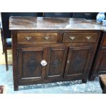 A late 17th/early 18th century oak cabinet having a pair of frieze drawers over cupboards incised