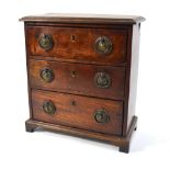 An early 19th century mahogany three-drawer miniature chest with brass plate and ring handles and