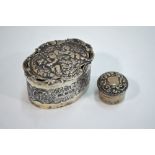 An Edwardian embossed silver oval box, the hinged cover decorated with cherubs and a pierced heart,