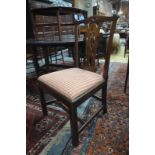 A set of four George III dining side chairs with moulded ear backs over vertical pierced splats and