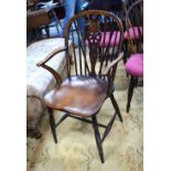 A 19th century elm seat wheelback Windsor elbow chair