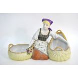 An Austrian porcelain posy vase modelled as a kneeling flower-girl with two baskets, 16 x 28 cm,