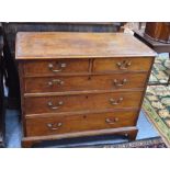 An 18th century oak chest of two short over three long graduated drawers with brass swan neck