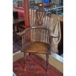 A 19th century elm seat comb back chair with flat arms,