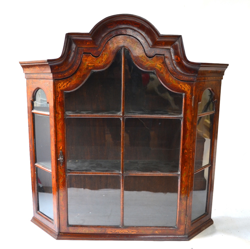 A 19th century Dutch floral marquetry walnut hanging display cabinet with moulded arched top over
