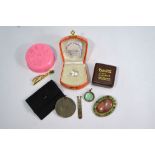 A collection of various items including jade tie clip,