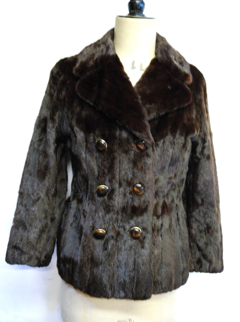 A dark brown squirrel fur double-breasted jacket with brown and gilt buttons,