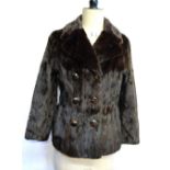 A dark brown squirrel fur double-breasted jacket with brown and gilt buttons,