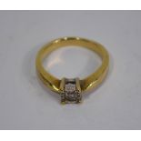 A single stone diamond ring set yellow metal stamped 375, the diamond approx 0.