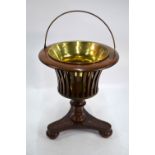 A 19th century walnut marquetry inlaid jardiniere stand with brass liner, raised on a triform base,