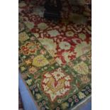 A handmade antiqued Agra carpet, the stylised floral design on soft coral and jade ground,