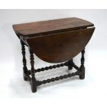 A 17th/18th century oak gateleg table, the oval drop leaf top over a frieze drawer to each end,