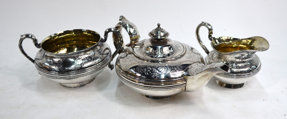 A William IV/Victorian silver matched three-piece bachelor tea service of compressed melon form,