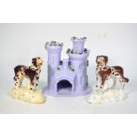 Two early 19th century Staffordshire pottery spaniels 12/13 cm high t/w a lilac pottery castle