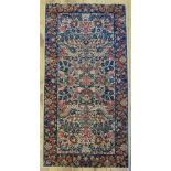 Antique Persian Kirman Lavar rug with floral design on camel ground and conforming navy border 116