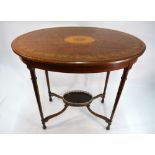 An Edwardian Sheraton revival inlaid satinwood centre table raised on slender turned legs united by