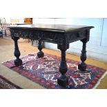 A Victorian oak library table in the Gothic style,