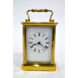 A brass carriage clock, the single train movement with white enamelled dial, in travel case,