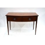 A Victorian mahogany bow front side table with two frieze drawers, raised on slender turned legs,