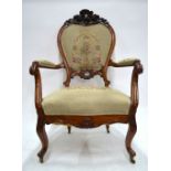 A French carved walnut framed petit point upholstered salon armchair