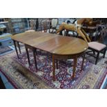 A Victorian mahogany three piece dining table comprising a pair of 'D' ends united by a drop leaf