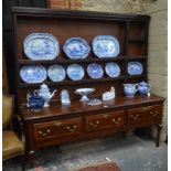 A part 18th century oak low dresser with associated composite three tier rack,