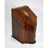 A George III mahogany serpentine form box, the hinged slope top centred by a shell motif,