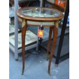 A late 19th century gilt-metal mounted kingwood vitrine table of ovoid form,