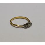 A three-stone old cut diamond ring, yellow and white metal set,