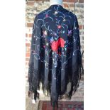 A Chinese silk black ground shawl, decorated with butterflies,