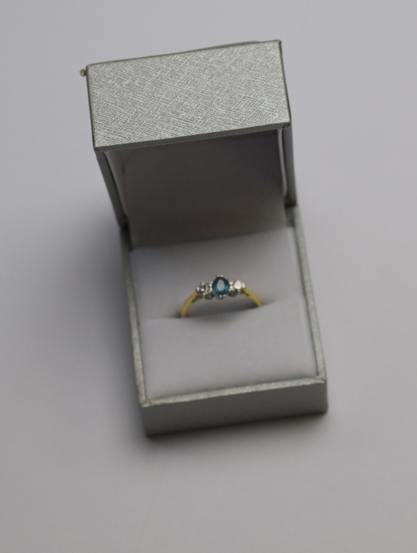 An oval blue topaz and brilliant cut dia