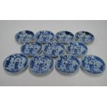 A set of eleven blue and white saucer dishes;