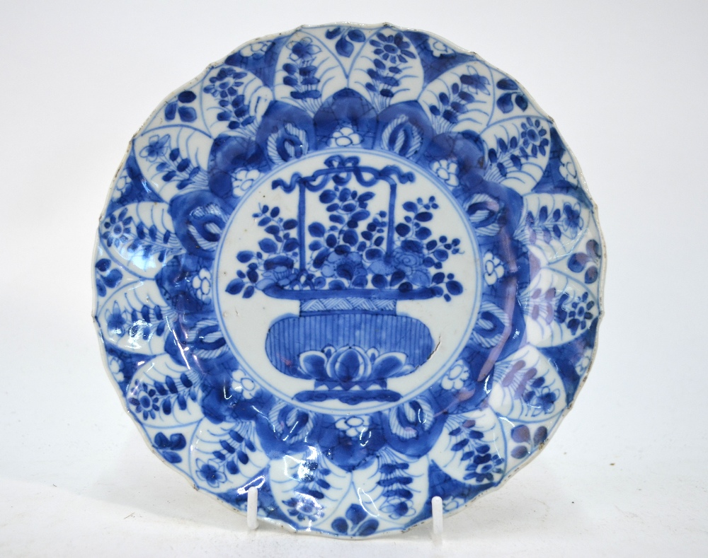 A Chinese blue and white dish, decorated with a central panel of a flower arrangement, 20.