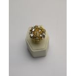 A large 1960s style cocktail ring, yello