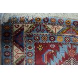 WITHDRAWN An old Anatolian Kuba triple pole design rug, on blue ground,