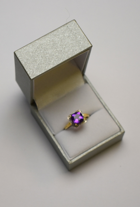 A square cut amethyst ring having small